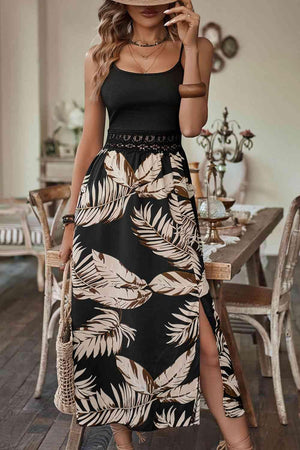 a woman wearing a black and white tropical print dress