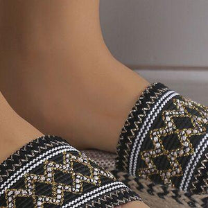 a close up of a person's feet wearing slippers