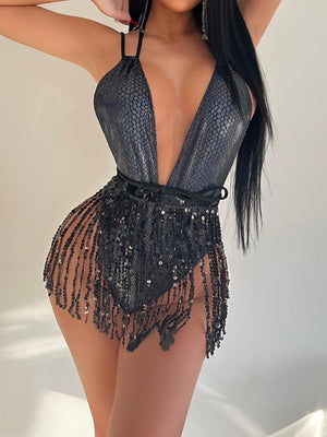 a woman in a silver bodysuit posing for a picture