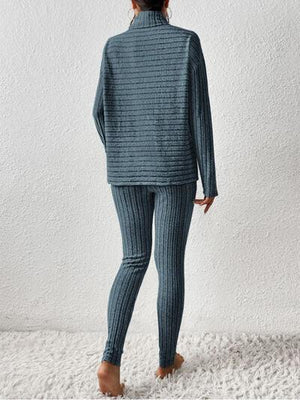 a woman in a blue sweater and leggings