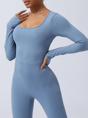 a woman in a blue bodysuit posing for a picture