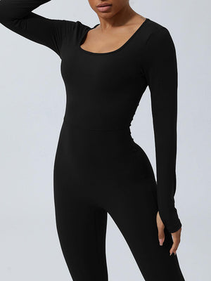 a woman in a black bodysuit posing for a picture
