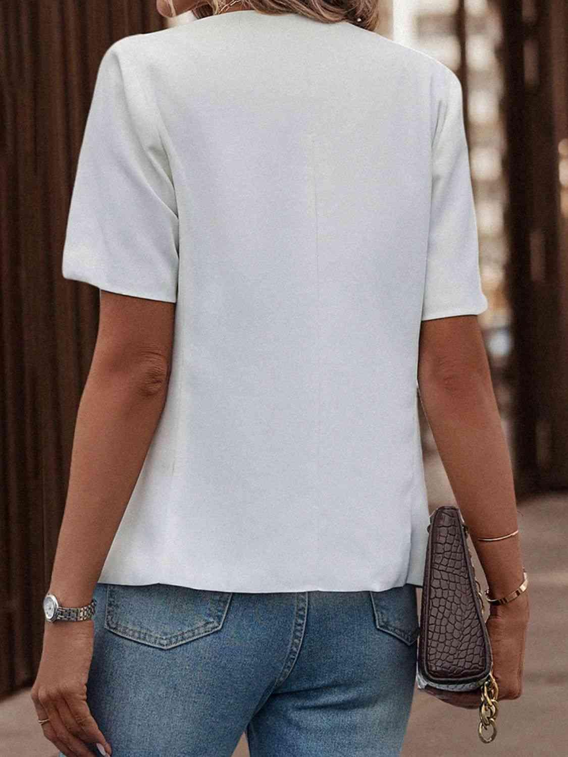 a woman wearing a white top and jeans