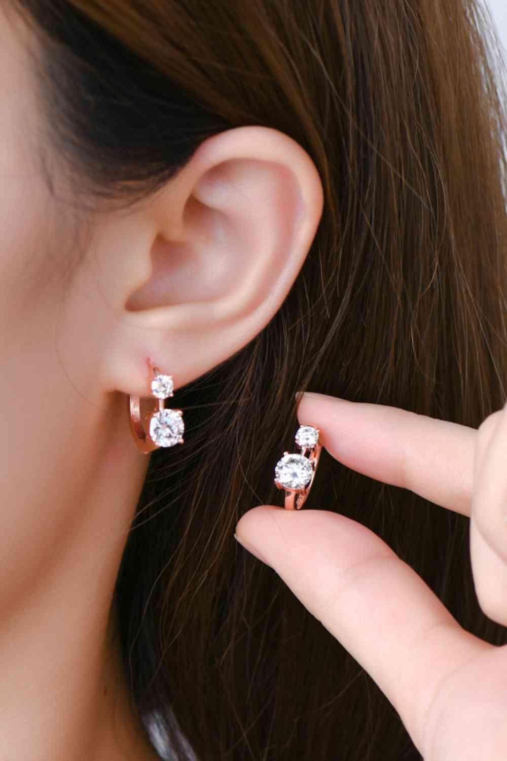 a close up of a person wearing a pair of earrings
