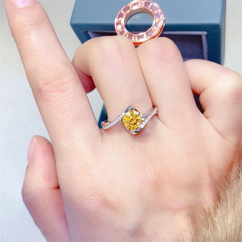 a close up of a person's hand holding a ring