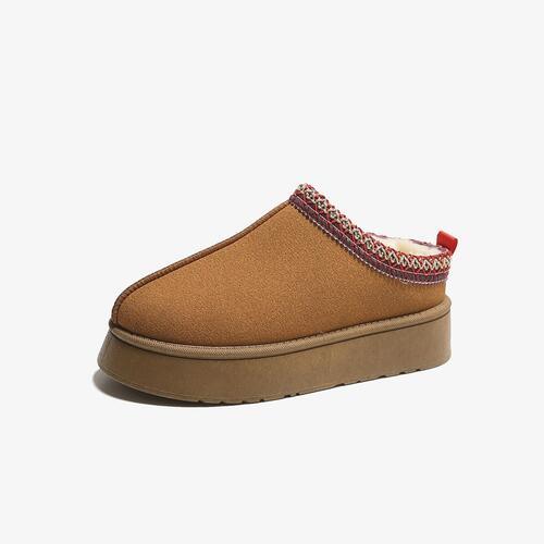 a pair of slippers with a brown sole