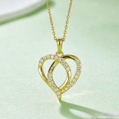 a gold necklace with a heart shaped pendant