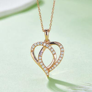 a heart shaped pendant with diamonds on a chain