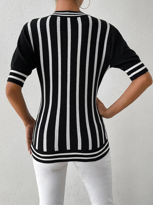 a woman wearing a black and white striped sweater
