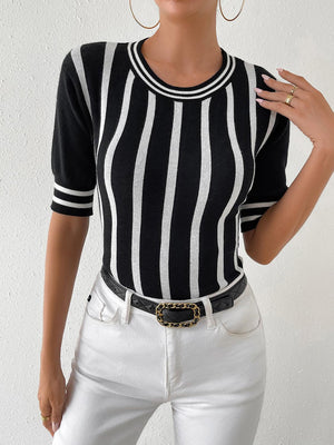 a woman wearing a black and white striped shirt