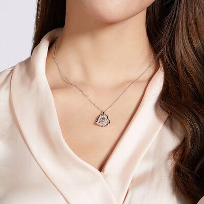 a woman wearing a necklace with a heart on it