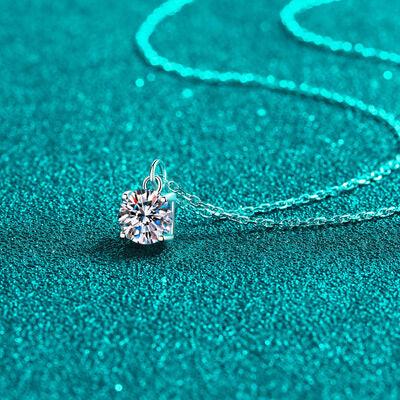 a necklace with a diamond on a blue surface