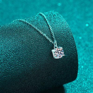 a close up of a diamond necklace on a green surface