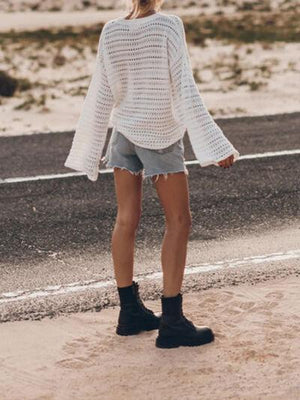 a woman standing on the side of a road