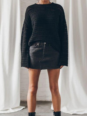a woman standing in front of a white curtain