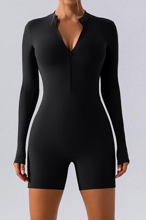 a woman wearing a black bodysuit with long sleeves