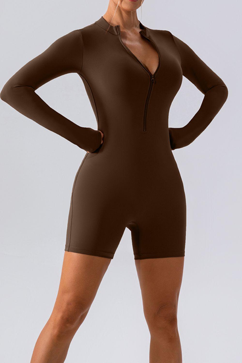 a woman in a brown bodysuit posing for a picture