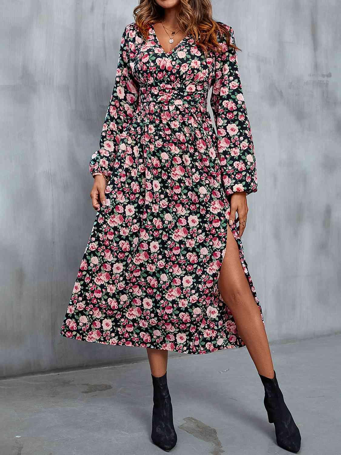 a woman wearing a black floral print dress
