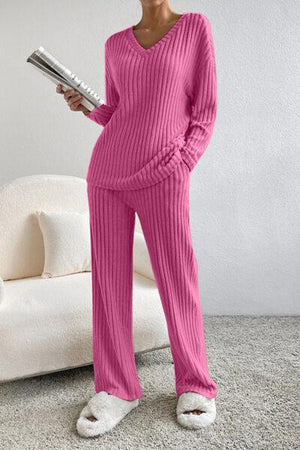 a woman in a pink sweater and matching pants