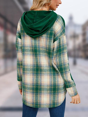 a woman wearing a green and white plaid jacket