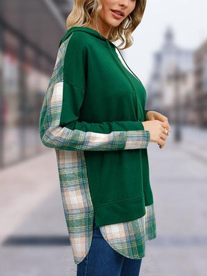 a woman wearing a green sweater and jeans