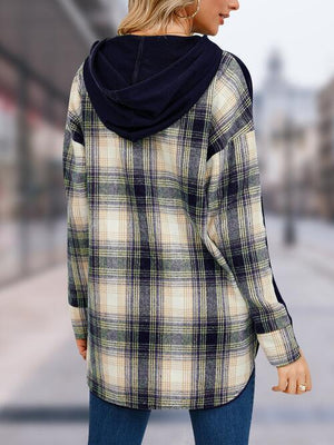 a woman wearing a plaid jacket and jeans