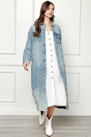a woman in a white dress and jean jacket