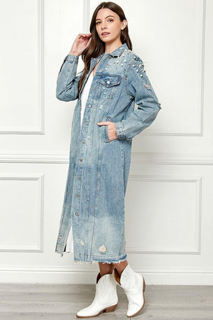 a woman wearing a jean jacket and white boots
