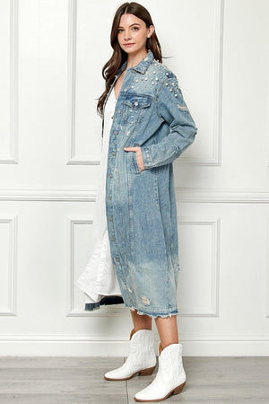 a woman wearing a denim jacket and white boots