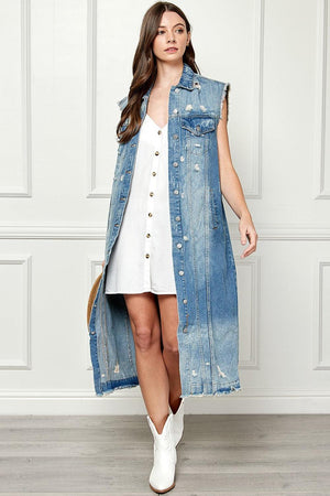 a woman in a white dress and jean vest