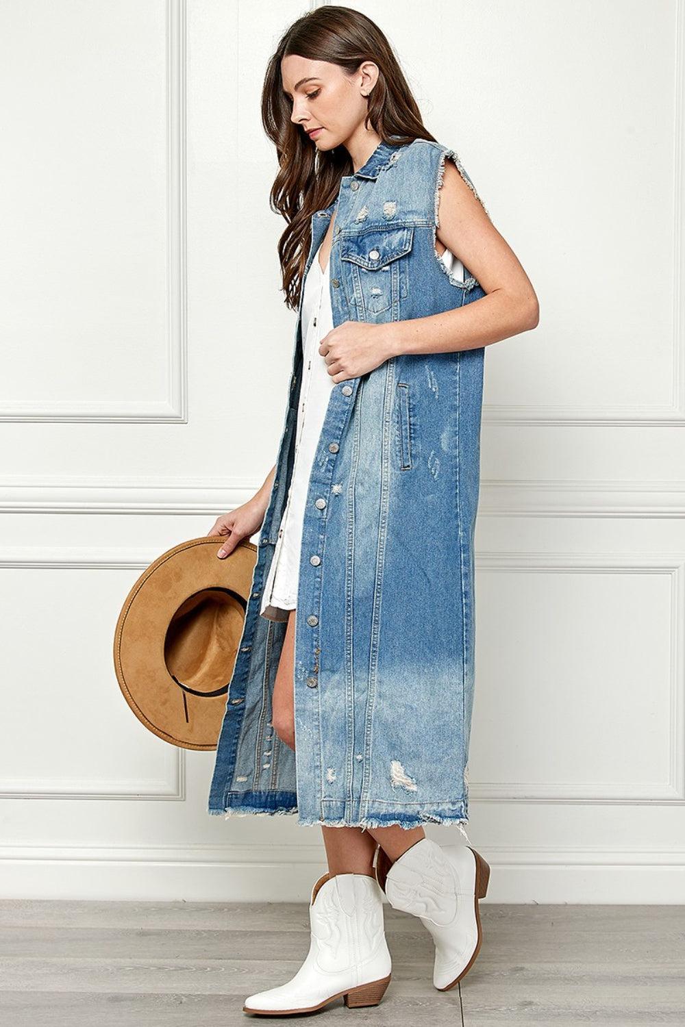 a woman wearing a denim vest and hat