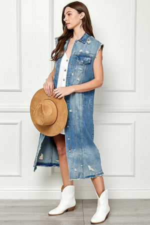 a woman wearing a denim dress and a hat