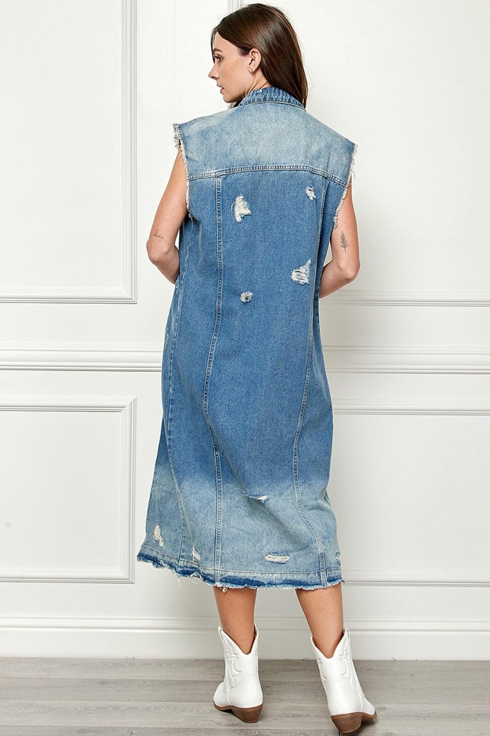 a woman wearing a denim dress with holes on it