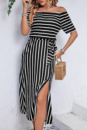 a woman wearing a black and white striped dress