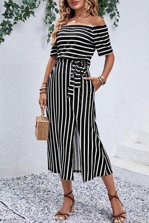 a woman wearing a black and white striped dress