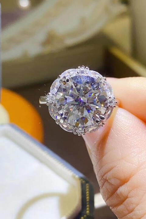 a person holding a diamond ring in their hand