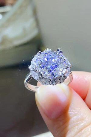 a close up of a person holding a ring