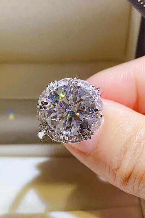 a person holding a diamond ring in their hand