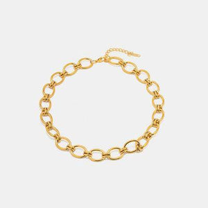 a gold chain bracelet on a white background