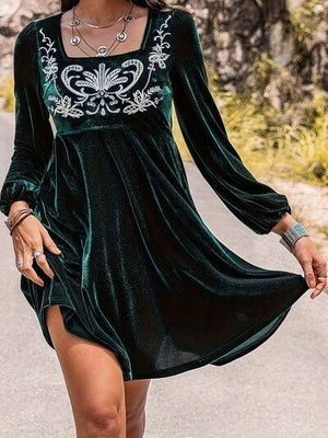 a woman wearing a green velvet dress