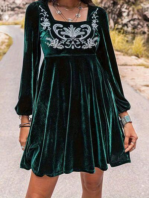 a woman wearing a green velvet dress
