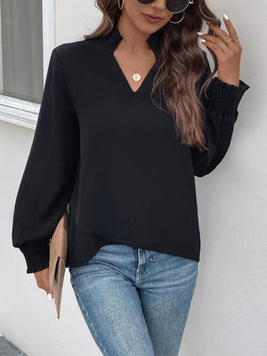 a woman wearing a black top and jeans