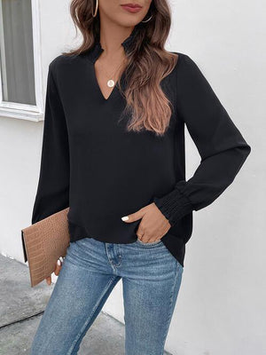a woman wearing a black blouse and jeans