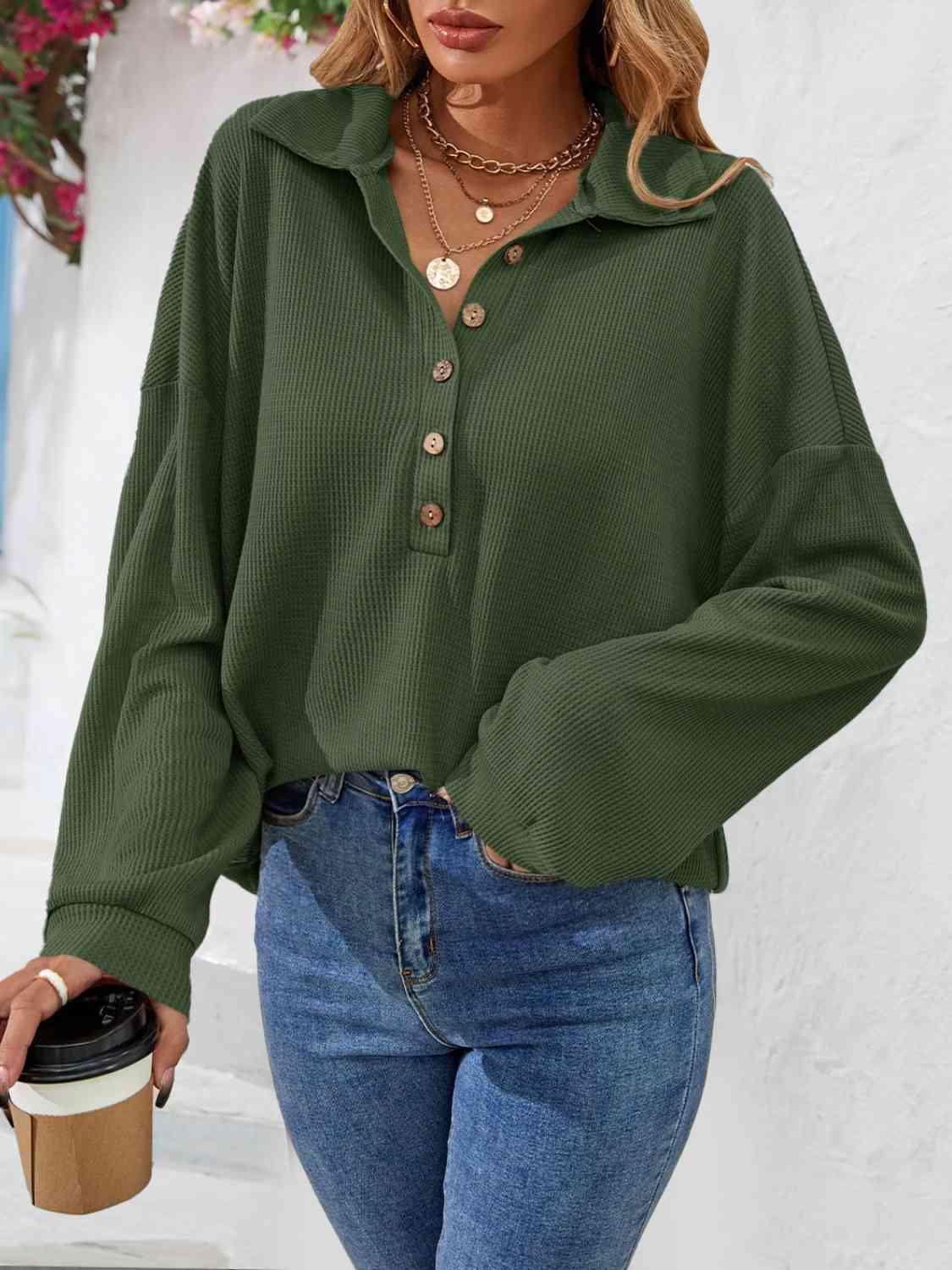 a woman wearing a green shirt and jeans