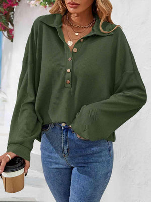 a woman wearing a green shirt and jeans
