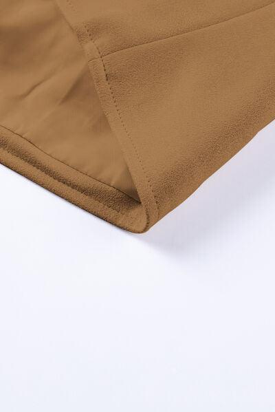 a close up of a tan pants on a white surface