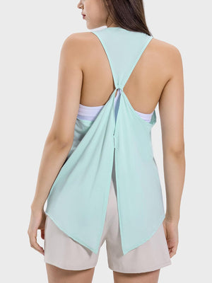 the back of a woman wearing a light blue top