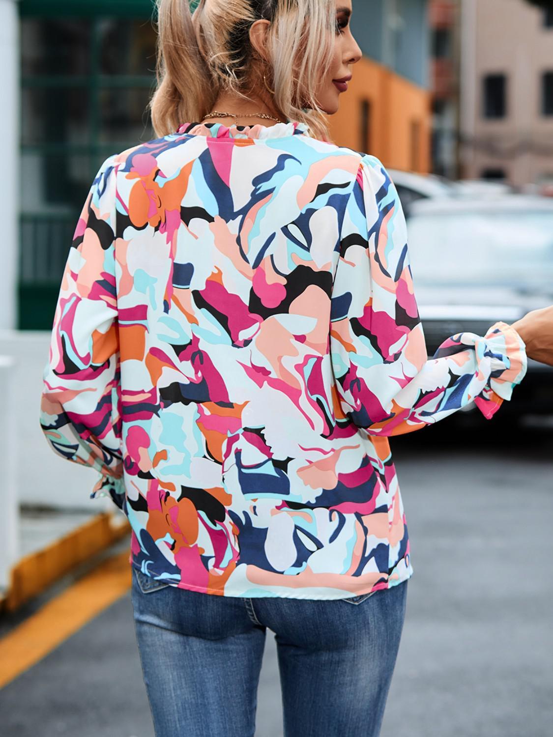 a woman walking down the street in a colorful top