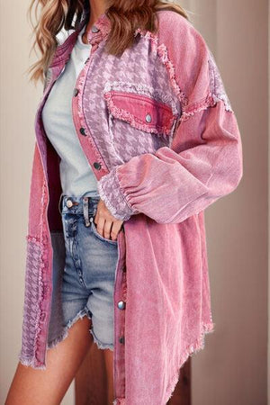 a woman wearing a pink jacket and denim shorts