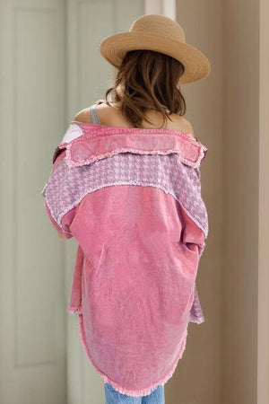 a woman wearing a pink shirt and a hat